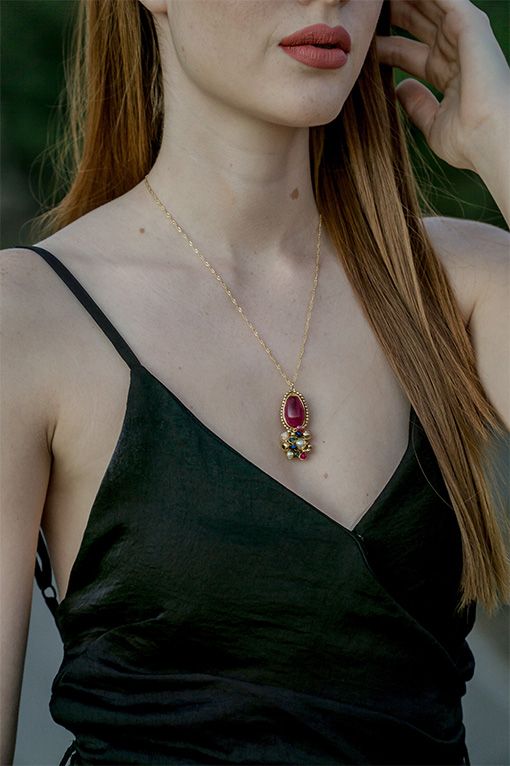 Image of a lady's neck wearing a stylish gold necklace